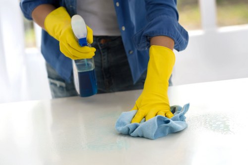 After builders cleaning team detailing kitchen surfaces in a renovated property